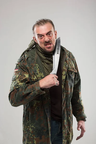 Man in soldier uniform holding knife — Stock Photo, Image