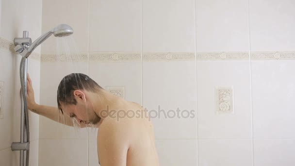 Мужчина моет волосы шампунем в душе. ванная комната . — стоковое видео