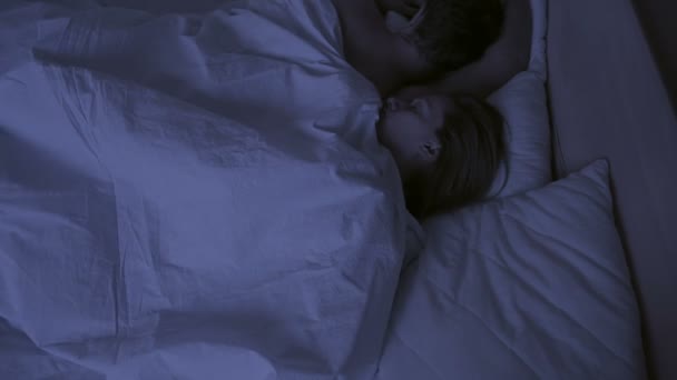 Concept of insomnia, the couple tosses in his sleep, a top view — Stock Video