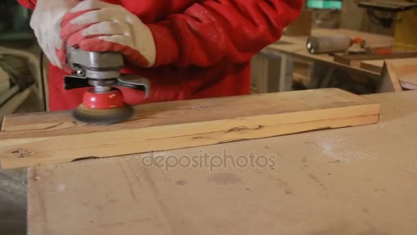 Carpenter grinds board grinding machine. close-up — Stock Footage Carpenter grinds board grinding machine. close-up Video Clip