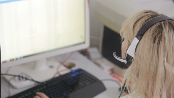 Close-up of business woman talking on headset in a call center — Stock Video