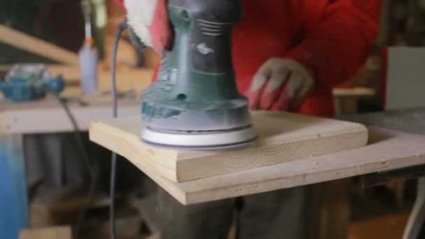 Carpenter grinds board grinding machine. close-up — Stock Footage Carpenter grinds board grinding machine. close-up Video Clip