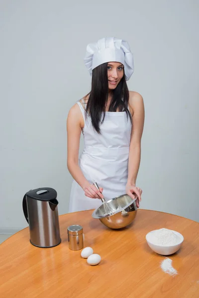 Sexy woman in chef uniform knead the dough — Stock Photo, Image