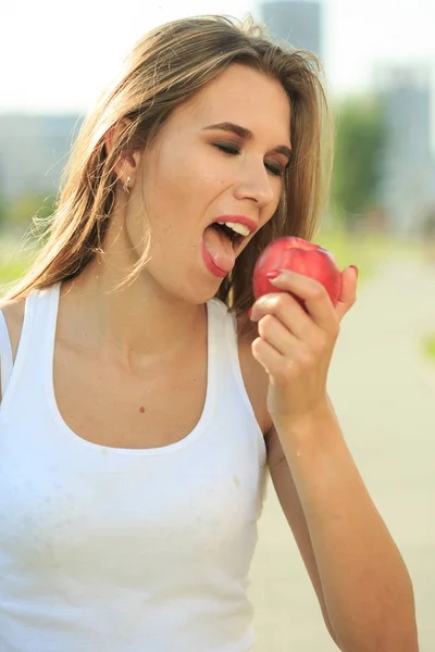 beautiful girl portrait holding apple. eating fruit