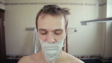 adam banyoda jilet ile onun sakalı tıraş
