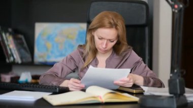 Bir bilgisayar ve Office belgeleri ile çalışan çekici kadın