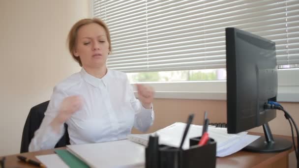 Woman manager tired of work doing physical exercises at the table in the office