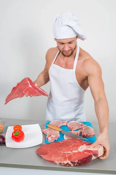 Chef-kok bodybuilder voorbereiding van grote brokken van rauw vlees. natuurlijke eiwitten — Stockfoto