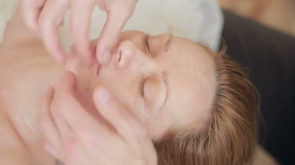 Mens handen doen gezichtsmassage voor een vrouw — Stockvideo