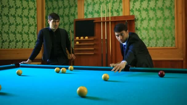 Playing billiards is shooting. Two men in suits play snooker. — Stock Video