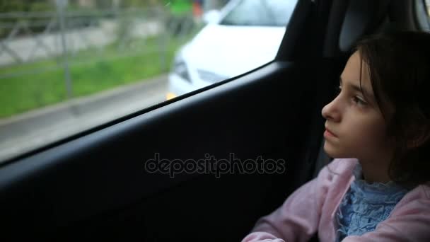 Petite fille, ennuyée dans la voiture - regardant par la fenêtre - reflet de rue — Video