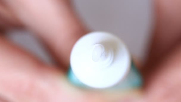 Crema bianca idratante spremuta da un tubo su uno sfondo bianco — Video Stock