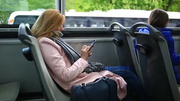 Akıllı telefon ile turistik gezi otobüsle seyahat genç güzel kadın — Stok video