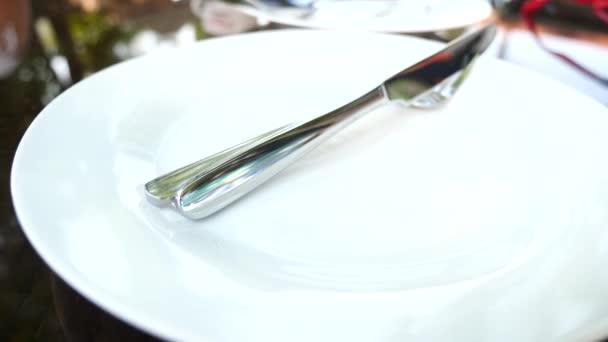 Empty white plate and cutlery on it. fork and knife. slow motion — Stock Video