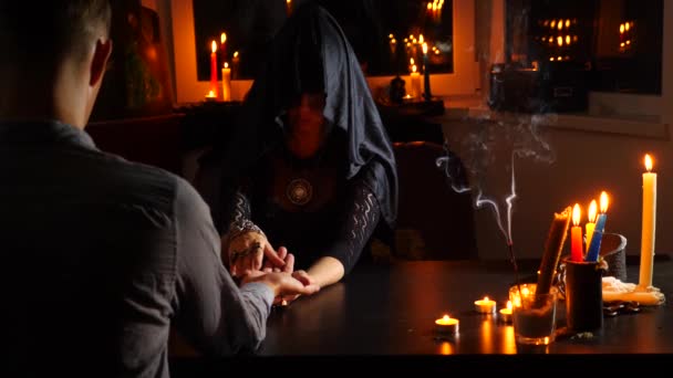 The witch is a fortune teller with candles close-up. A magical ritual. divination. Halloween, 4k, slow-motion — Stock Video