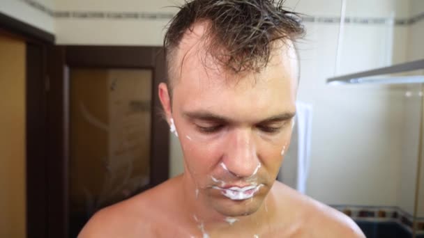 Man shaves his face. handsome man shaving in the bathroom. 4k, slow motion — Stock Video