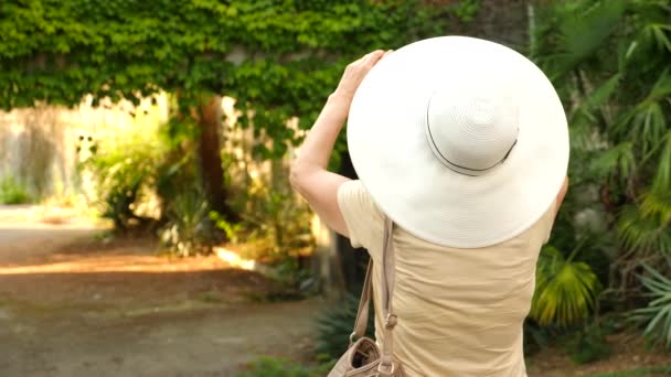 Beautiful elderly woman or tourist taking a photograph with mobile cellphone smartphone. Lady to share pic on social media photo site. 4k. Slow motion — Stock Video