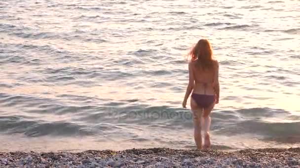 Pregnant woman stroking belly on the seashore. 4k. Slow motion — Stock Video