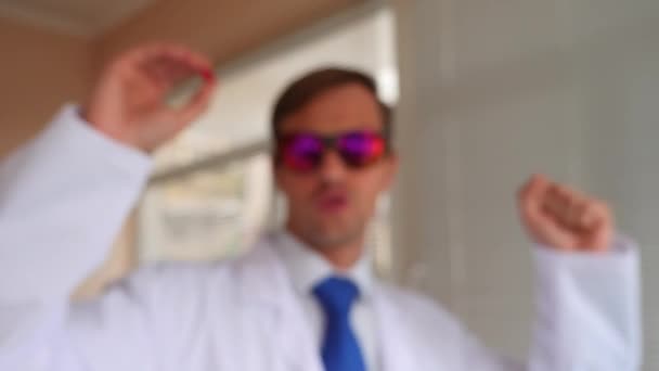 Deli Profesör doktor kırmızı gözlük bir hap hücreye sunmaktadır. 4k, ağır çekim — Stok video