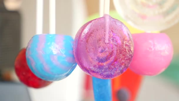 Colorful lollipops hang in the air. 4k slow motion — Stock Video