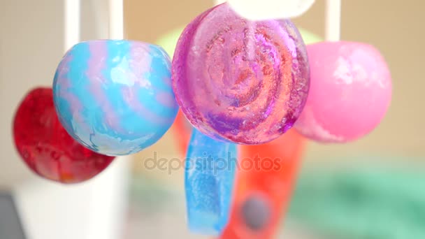 Colorful lollipops hang in the air. 4k slow motion — Stock Video