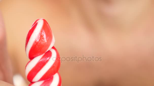 Sexy guy eating a lollipop. simulation of oral sex. tongue licking candy, 4k, slow motion. copy space — Stock Video