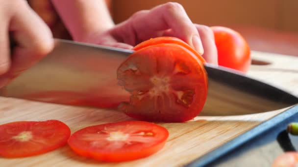 Tagli di coltello pomodoro su tavola di legno. 4k, rallenta. primo piano — Video Stock