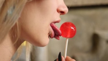 bodymification. bir kız bir split dil ile lolipop yalıyor. 4k, ağır çekim silah, kopyalama alanı
