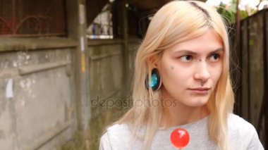 bodymification. bir kız bir split dil ile lolipop yalıyor. 4k, ağır çekim silah, kopyalama alanı