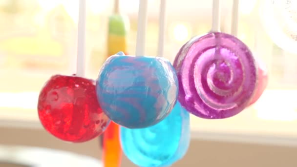 Colorful lollipops hang in the air. 4k slow motion — Stock Video