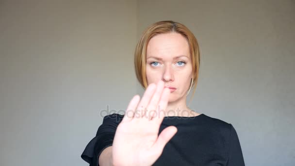 4k. Close up of beautiful blonde woman with bright blue eyes. portrait of a young woman. body language and gestures. disagreement, refusal. she shows her palm, which means stop. — Stock Video