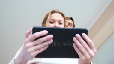 4 k. ağır çekim. genç kadın ve adam tablet vasıl bakan gözleri makro yakın çekim şaşırttı,