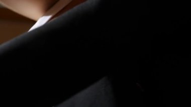 bir kadınla güzel bir göğüs üzerinde siyah bir ceket koyar. 4k, ağır çekim