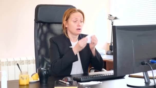 Sick business woman with flu blowing nose in tissue. in the office. 4k, slow motion — Stock Video