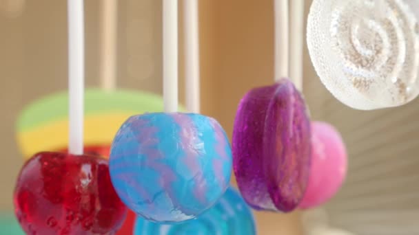 Colorful lollipops hang in the air. 4k slow motion — Stock Video