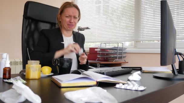 Kobieta biznesu chorych z grypy dmuchanie nosa w tkance. w biurze. 4k — Wideo stockowe