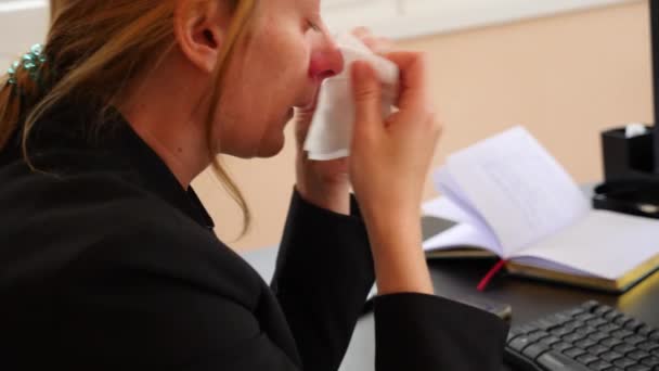 Sick business woman with flu blowing nose in tissue. in the office. 4k, slow motion — Stock Video