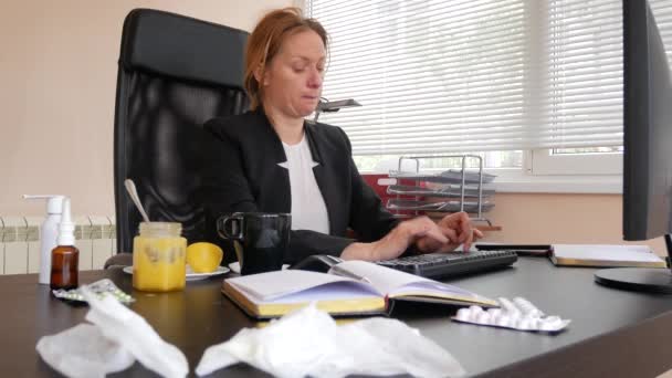 Sick business woman with flu blowing nose in tissue. in the office. 4k — Stock Video