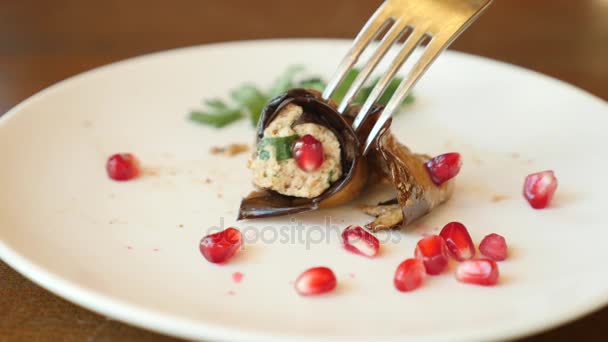 Someone eats in a restaurant of national cuisine Eggplants with walnuts. Delicious roasted aubergines with nuts, herbs and pomegranate seeds. A dish of Georgian cuisine. — Stock Video