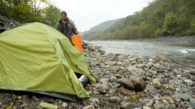 4 bir adam ve bir kız bir turist yakınındaki çadırın bir dağ nehir kıyısında k..