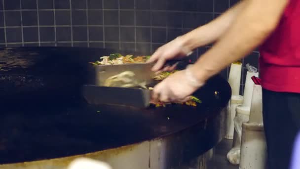 El cocinero en el restaurante de cocina abierta prepara carne y verduras en la parrilla de Mongolia. 4k, cámara lenta — Vídeos de Stock