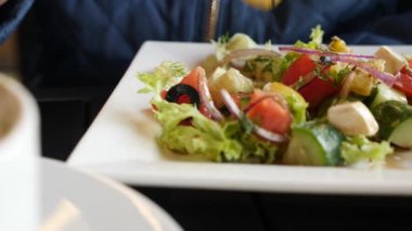 birisi bir fast food Restoran Yunan salatası yiyor. 4k, yavaş hareket yakın çekim
