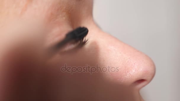 Occhio in macro filmato di giovane donna che applica il mascara sulle ciglia. 4k, rallentatore — Video Stock