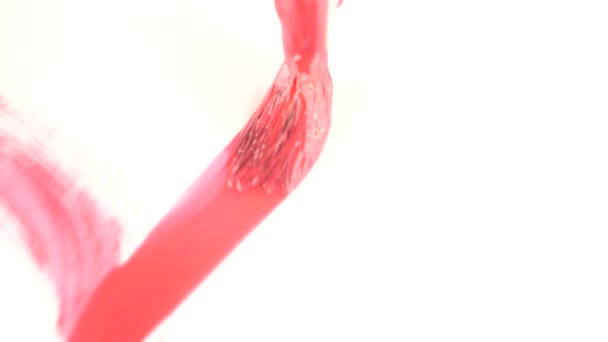 Someone draws paint on a white sheet. close-up of a tassel. 4k, slow motion. draw a heart with red paint — Stock Video
