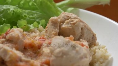 diyet yemek. Tavuk fileto ve sebze sos ile kahverengi pirinç. taze marul. Yakın çekim. 4 k, yavaş hareket, dolly atış