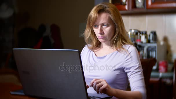 a woman in a bathrobe and with wet hair sitting at home on the couch, watching changes in the currency exchange chart, looking at the computer monitor, freelancing, 4k, blurring the background