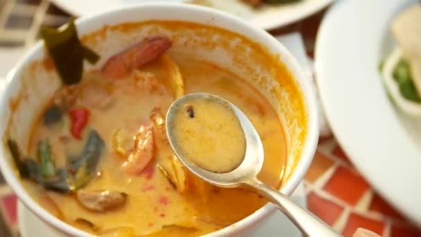 Prawn spicy soup is a Thai dish with sour and spicy taste. some are scooping prawn spicy soup. 4k, slow-motion, close-up — Stock Video