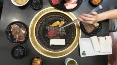 Korece barbekü ızgara. aşçı insanlar ve bir restoranda Kore bir ızgarada pişmiş yemekler yiyin. 4k, yakın çekim.