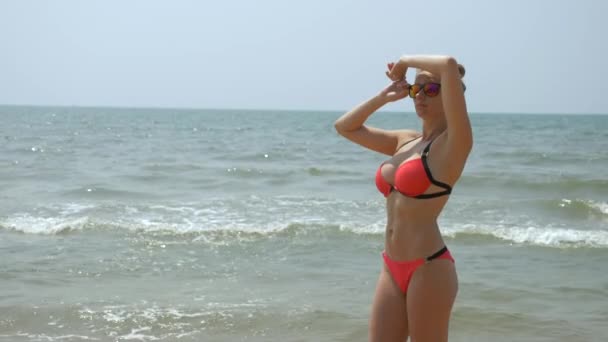 Szép, fiatal lány a strandon, vissza visel piros bikini szexi segg trópusi vakáció lassítva. közelről. 4k — Stock videók