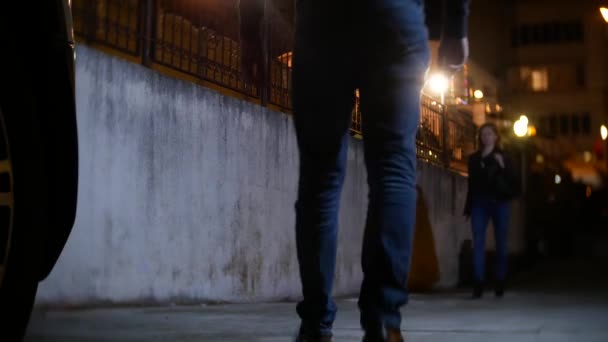 Мужчина-грабитель, угрожает женщине и забирает ее сумочку, в темном переулке. ночью — стоковое видео